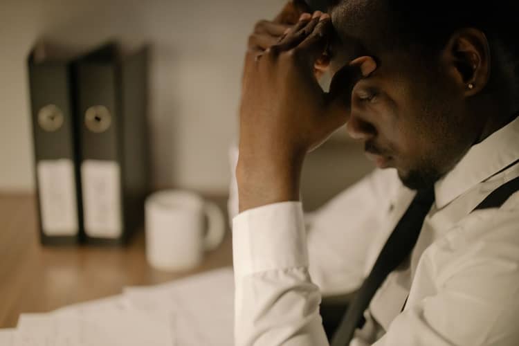 A business owner weighed down by financial uncertainty