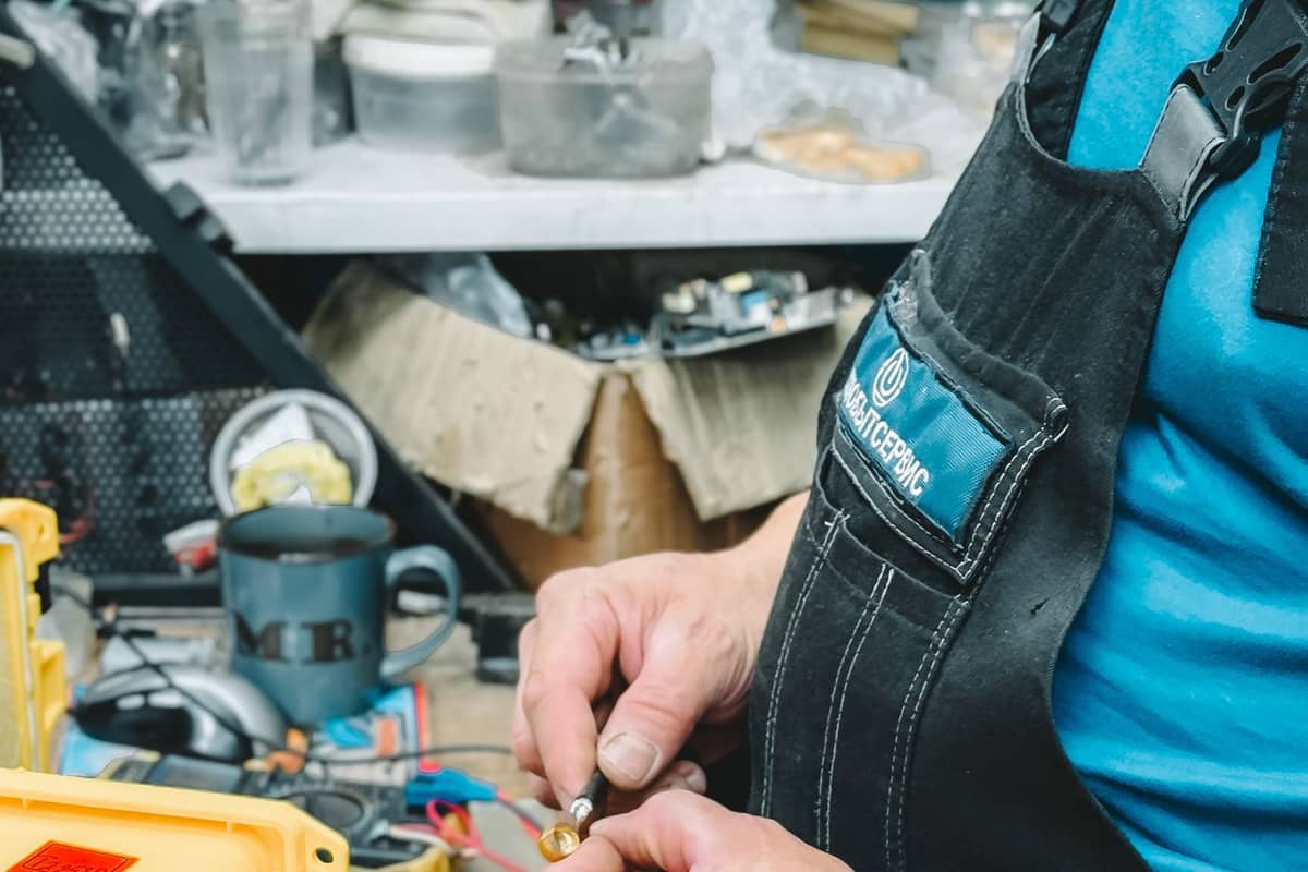 Electrician working on a circuit in a workshop