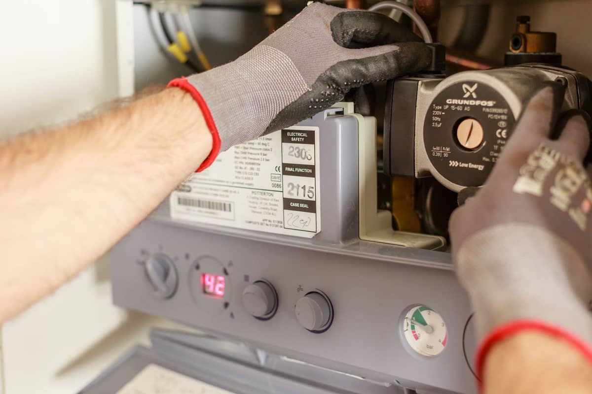 Plumber servicing a boiler and water system