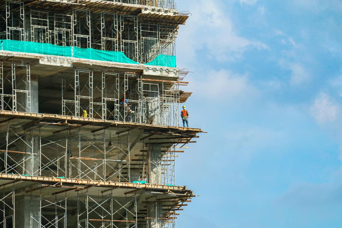 Commercial building under construction against a clear sky