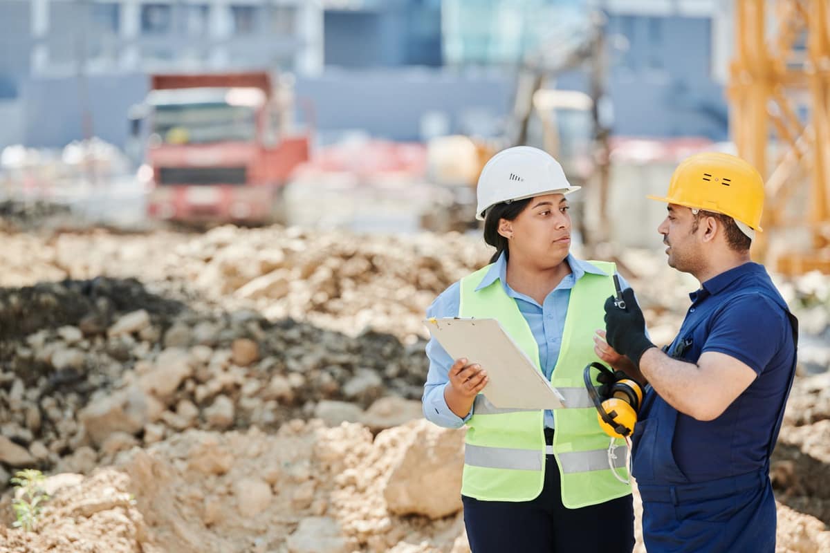 Two construction professionals reviewing work on an active job site