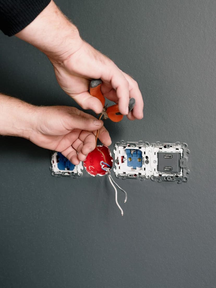 Electrician wiring outlets and switches