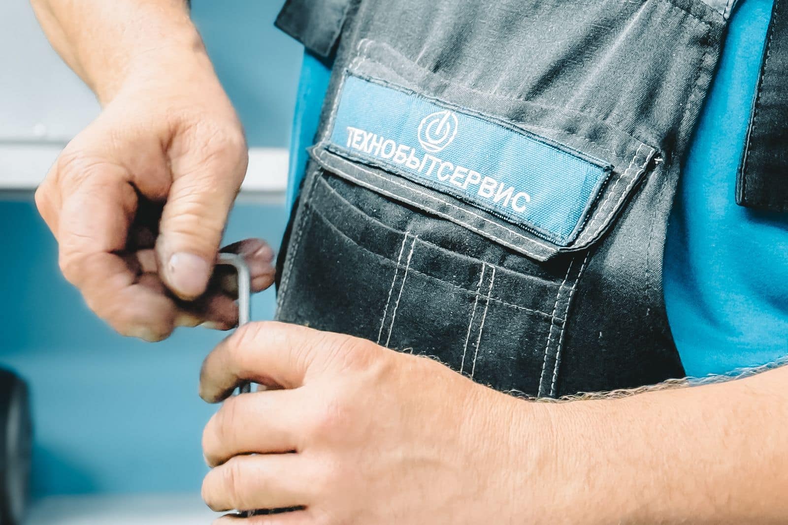 Plumber repairing a pipe with a wrench