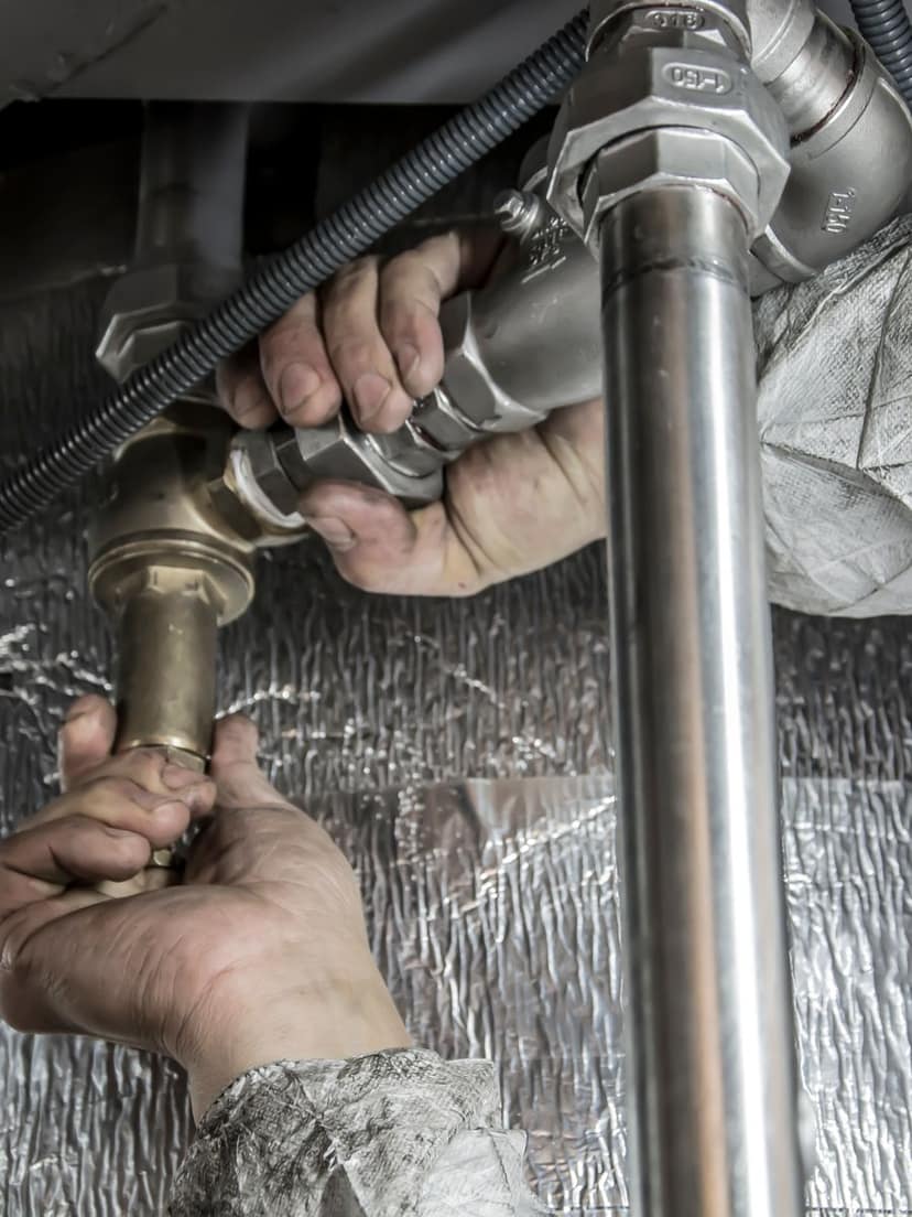 Plumber installing steel pipes on a job