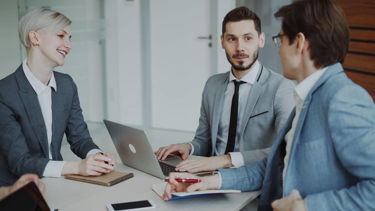 Two professional services partners reviewing figures together in a bright meeting room