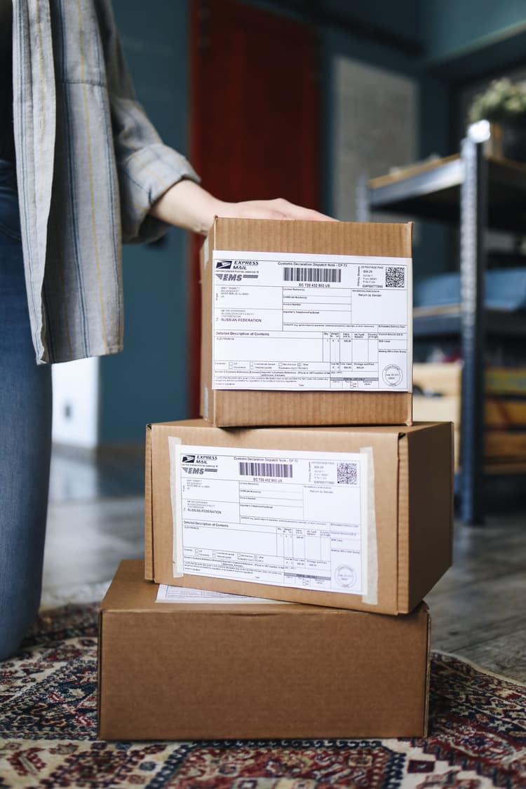 E-commerce seller packing and shipping customer orders