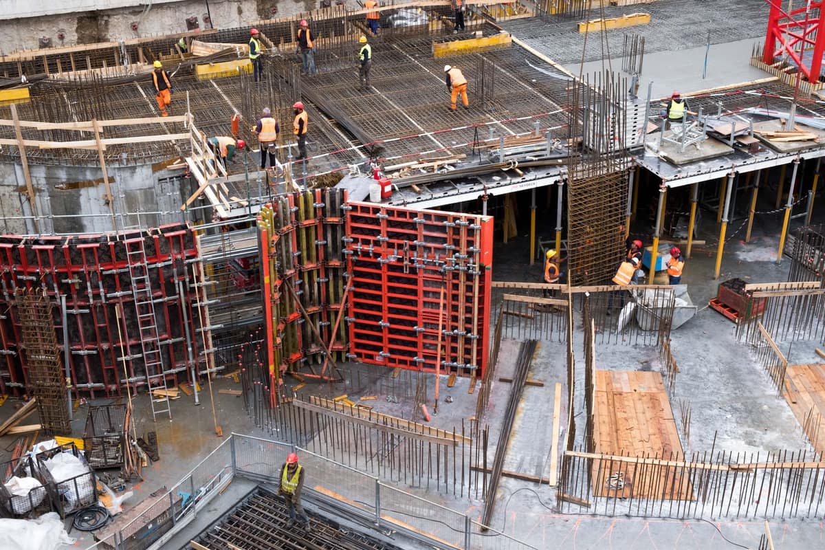 Several trades working formwork and rebar on a commercial deck